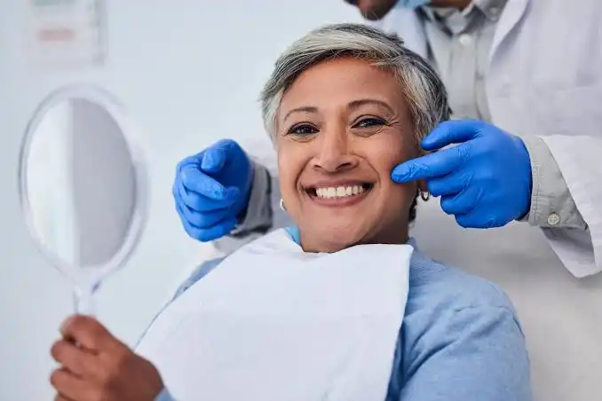 Patient smiling after All On 4 Implants In North London full-arch dental implant treatment.