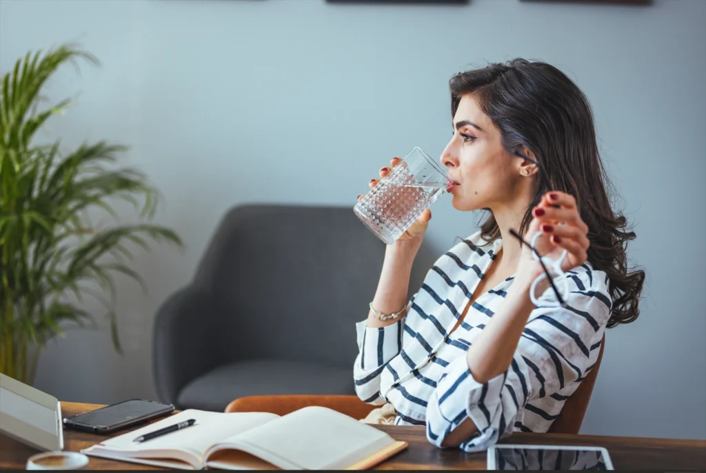 Patient drinking plain sparkling water after Dental Implants In London