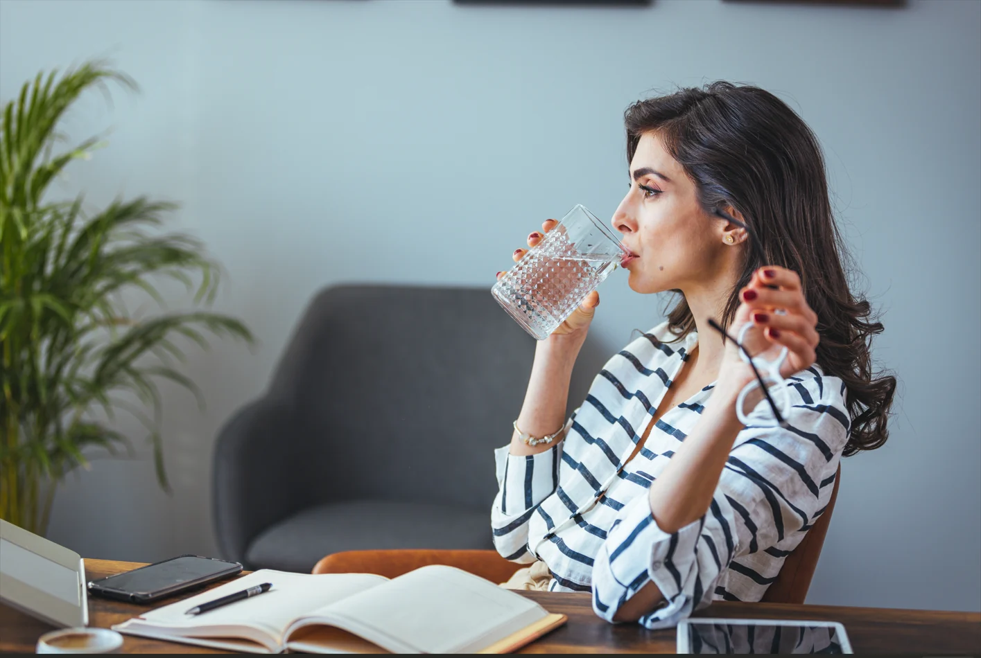 Patient drinking plain sparkling water after Dental Implants In London